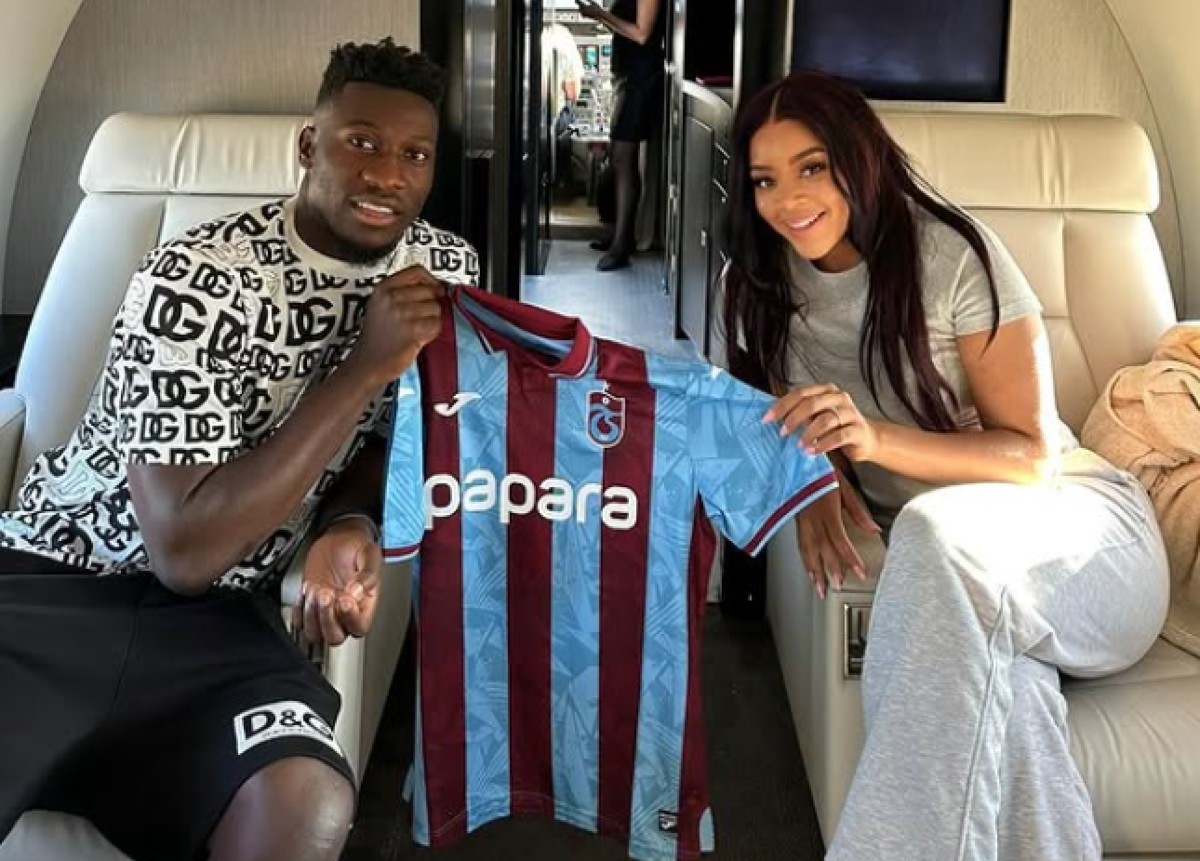 Andre Onana and wife Melanie Kamayou pictured holding a Trabzonspor shirt on a private jet