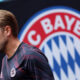 Harry Kane next to a giant Bayern Munich badge at the Club World Cup