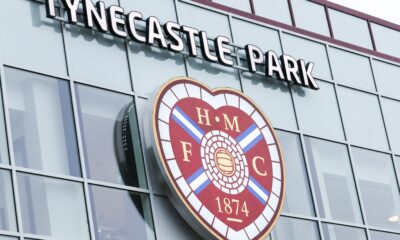 A general photo of the Tynecastle Park sign and Hearts badge