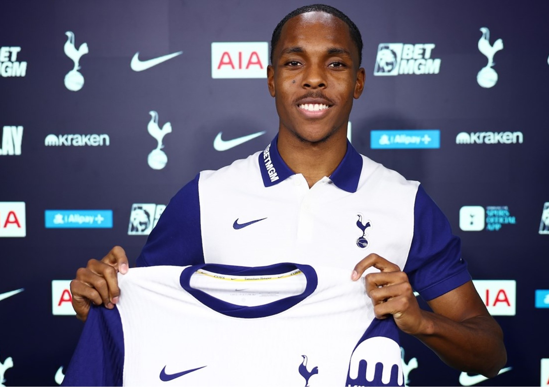 Mathys Tel pictured posing with a Spurs shirt after signing from Bayern Munich in 2025