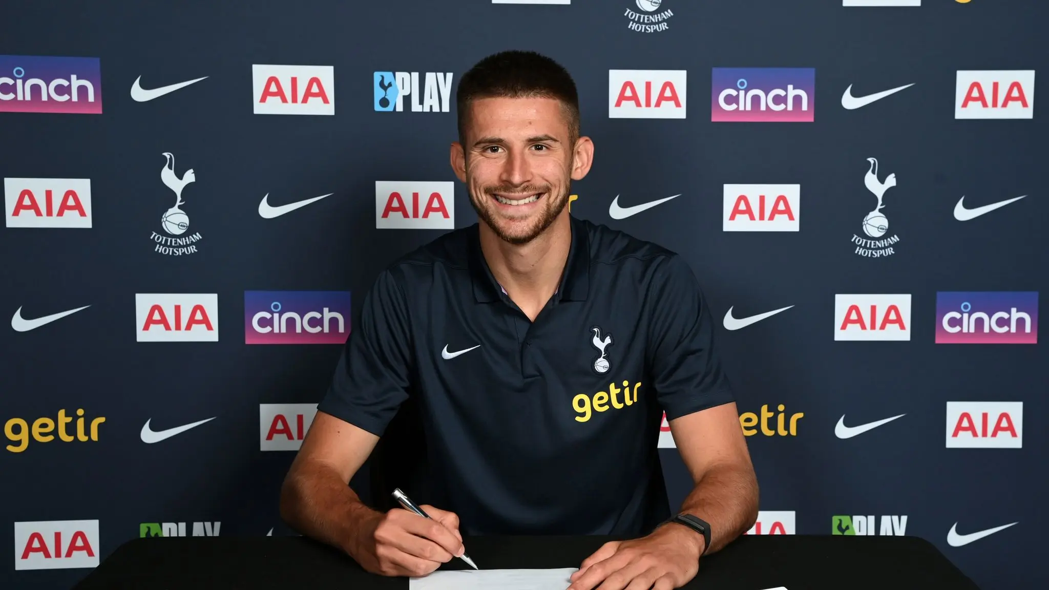 Guglielmo Vicario signing with Tottenham Hotspur at a promotional event.