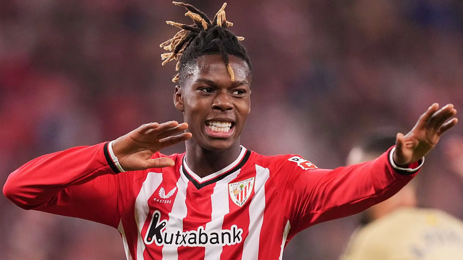 Nico Williams celebrating in Athletic Bilbao's red and white jersey during a match.