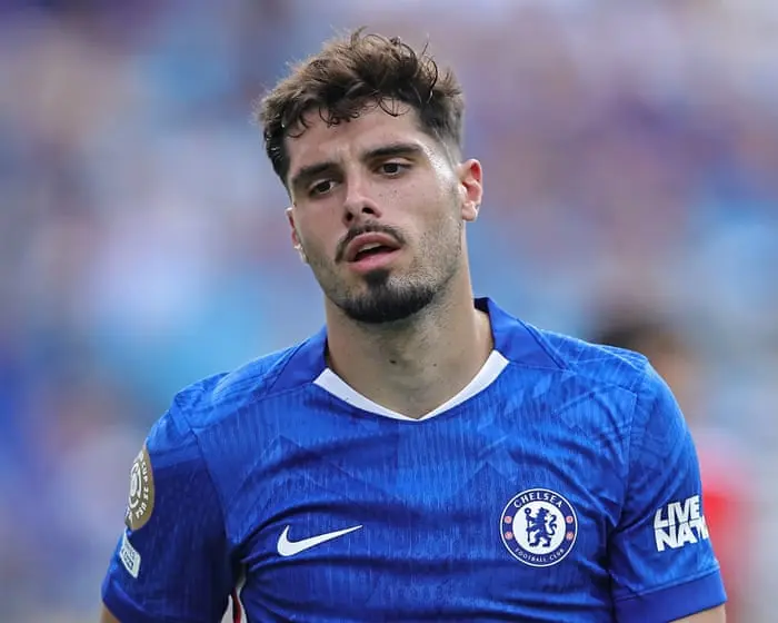 Chelsea player in blue kit showing a disappointed expression during a match.