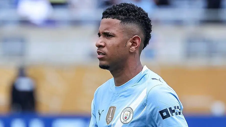 Savinho, Manchester City winger, in a blue kit during a match.