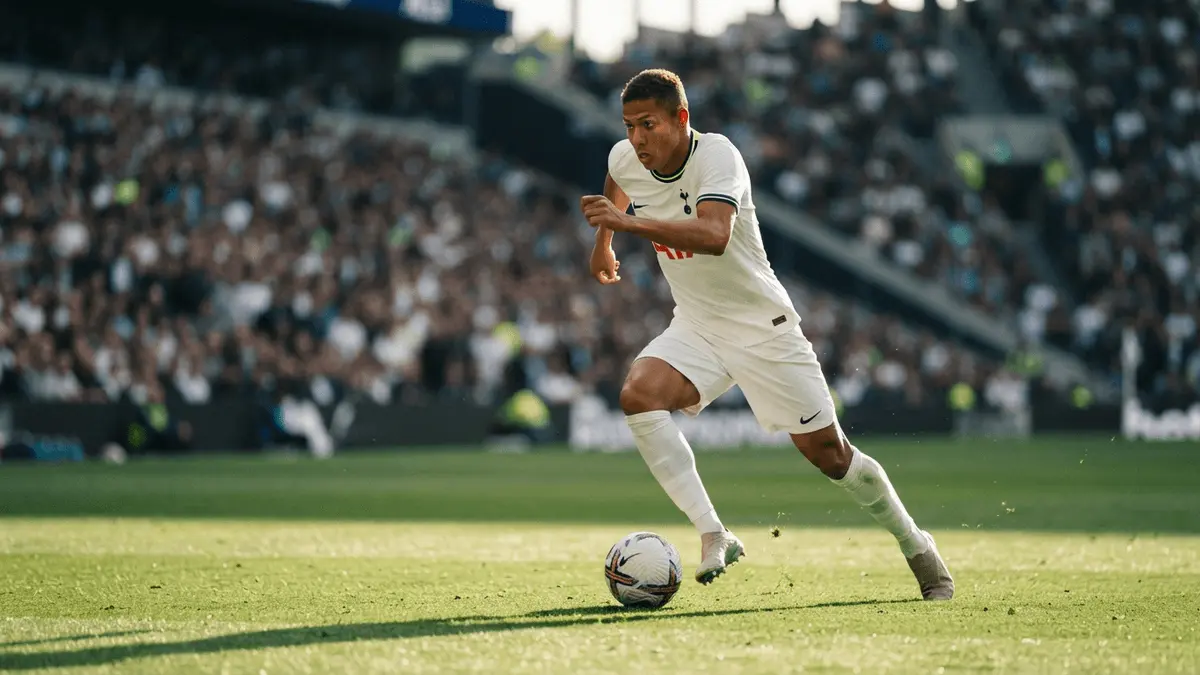 Brazilian winger in Tottenham kit dribbling during Premier League match